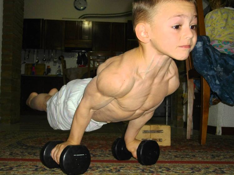 Photo of Giuliano Stroe doing push ups on dumbbells